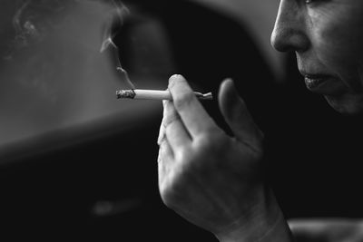 Close-up of man smoking cigarette