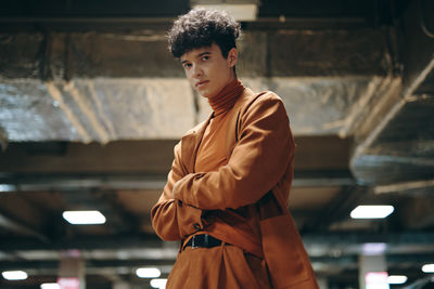 Side view of young man standing outdoors