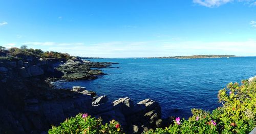 Scenic view of sea against blue sky