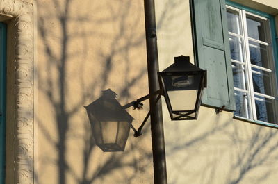 Low angle view of street light against building