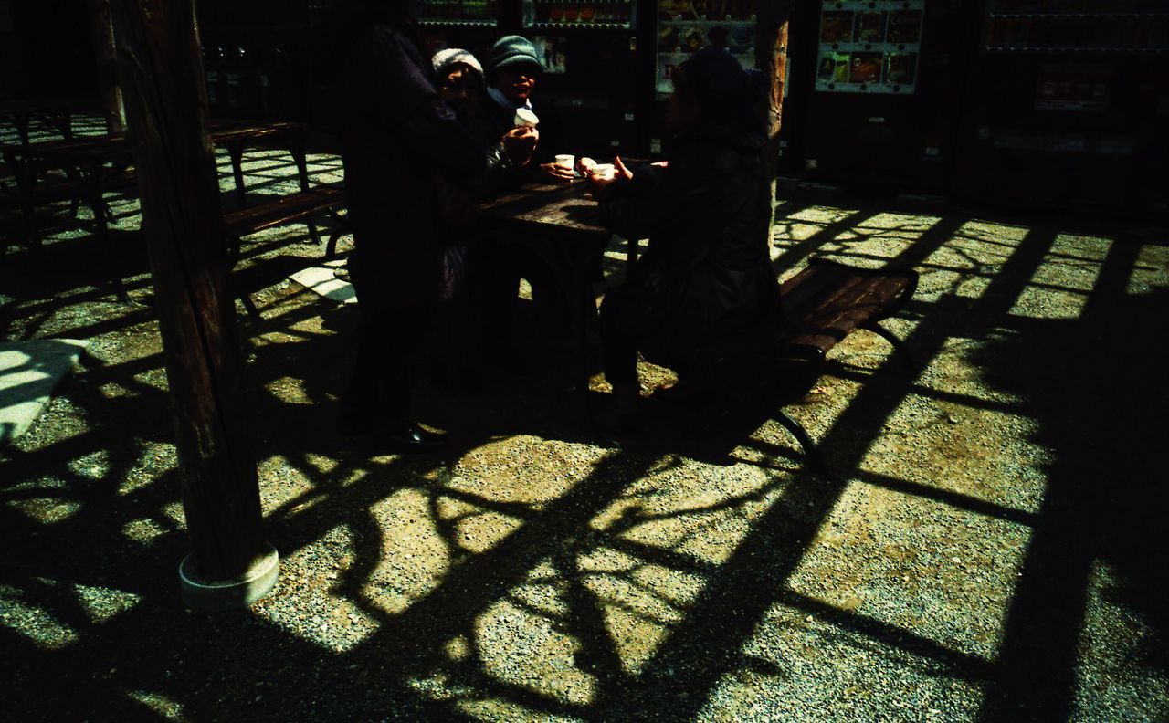 shadow, sunlight, real people, cafe, table, sitting, two people, day, men, outdoors, lifestyles, city, people, adult