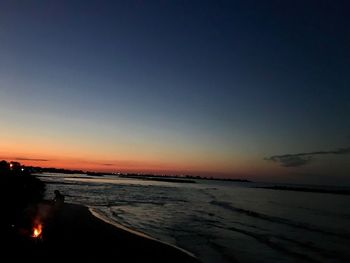 Scenic view of sea against clear sky during sunset