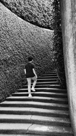 Rear view of woman walking on staircase