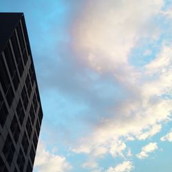 Low angle view of building against cloudy sky