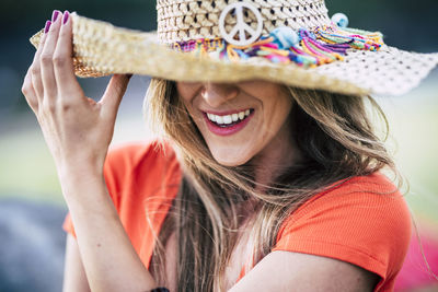 Close-up of smiling young woman in hat