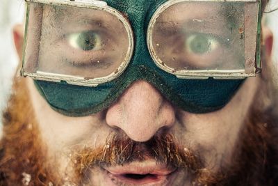 Close-up portrait of man wearing goggles during winter