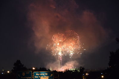 Low angle view of firework display at night