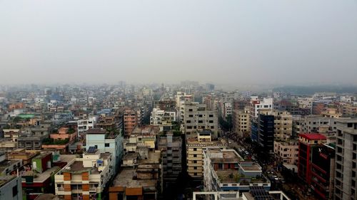 High angle view of buildings in city against clear sky