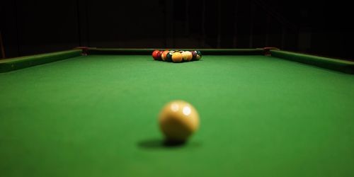 Close-up of pool balls on table against black background