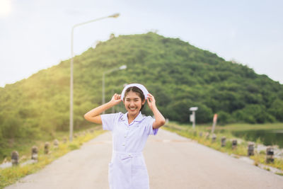 Smiling young nurse on field