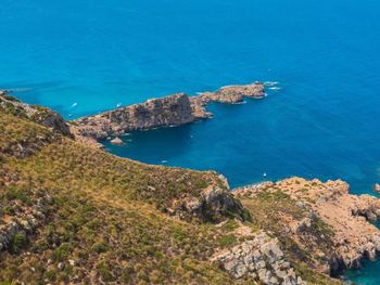 High angle view of sea against clear blue sky