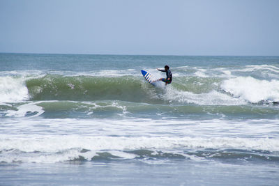 People surfing in sea