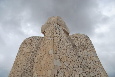 Low angle view of statue against cloudy sky