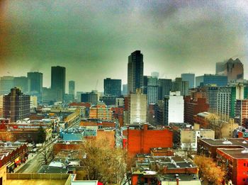 Buildings against cloudy sky