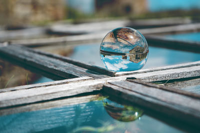 Close-up of crystal ball on wooden frame