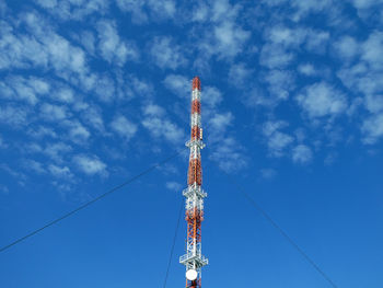 Low angle view of communications tower against sky