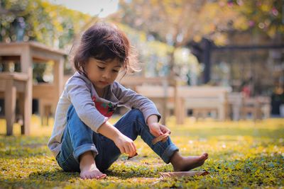 Boy playing in park during autumn