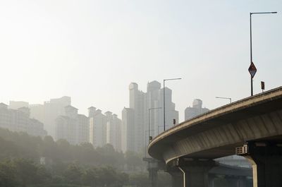 Buildings in city against clear sky