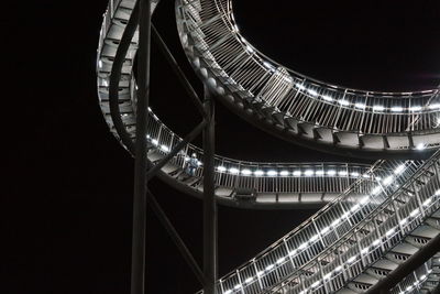 Low angle view of illuminated ferris wheel against sky at night