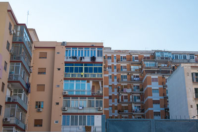 Buildings in city against clear sky