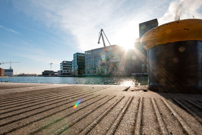 Pier on beach against sky in city