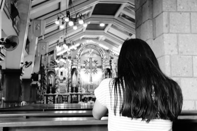 Rear view of teenage girl in church
