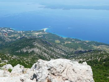 Scenic view of sea and mountains against sky