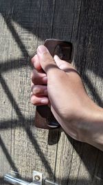 Cropped hand of person holding handlebar 