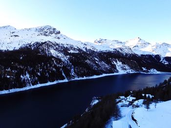 Scenic view of snowcapped mountains against clear sky