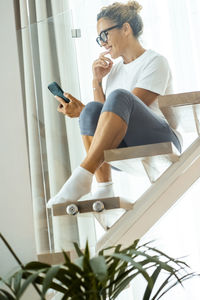 Side view of young man using mobile phone