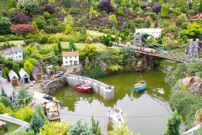 High angle view of boats moored on river by trees