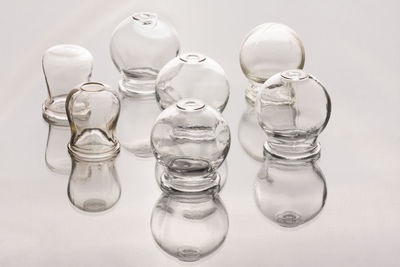 High angle view of various glasses against white background