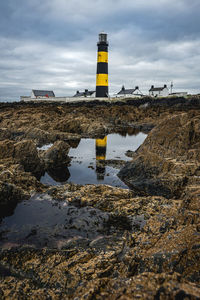 Surface level view of road leading towards beach against sky