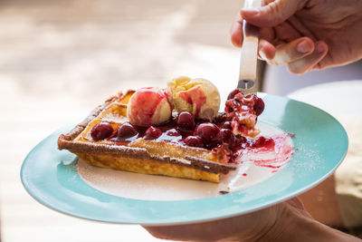 High angle view of hand holding ice cream