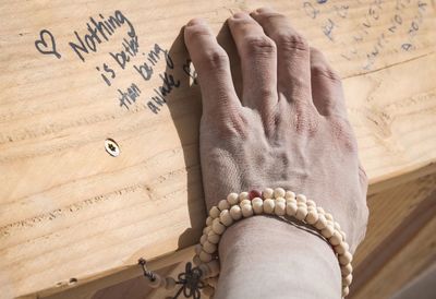 Cropped hand touching wooden box