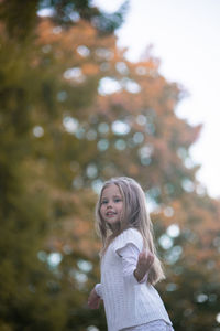 Beautiful little child girl walking in a park