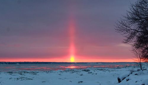 Scenic view of rainbow against sky during winter