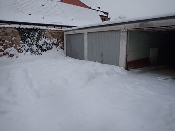 Snow covered houses by building