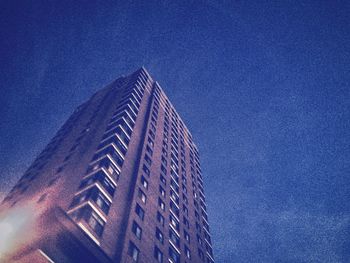 Low angle view of modern buildings against blue sky