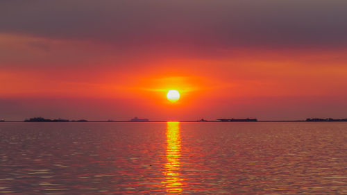 Scenic view of sea against romantic sky at sunset