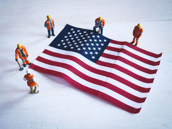 High angle view of american flag with figurines on table