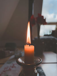 Close-up of lit tea light candles in temple