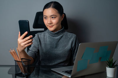 Young woman using mobile phone