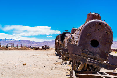 Abandoned train on land against sky