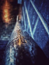 Close-up of wet metal on street during rainy season