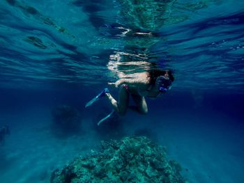 Young woman snorkeling undersea