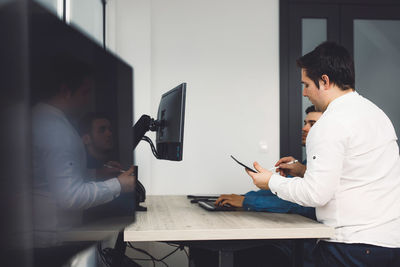 Side view of man working at office