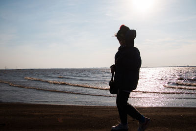 Boy walking by the sea