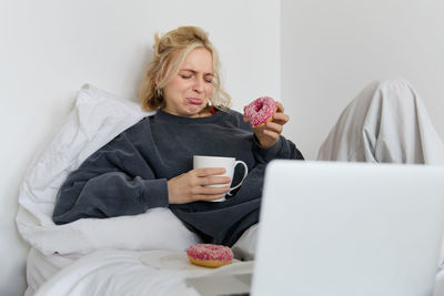 Portrait of woman using laptop at home