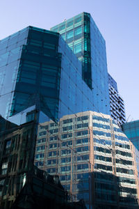 Low angle view of office building against blue sky